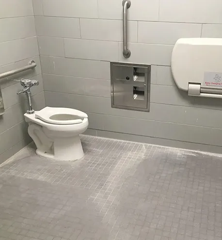 Clean commercial bathroom floor after professional cleaning service.