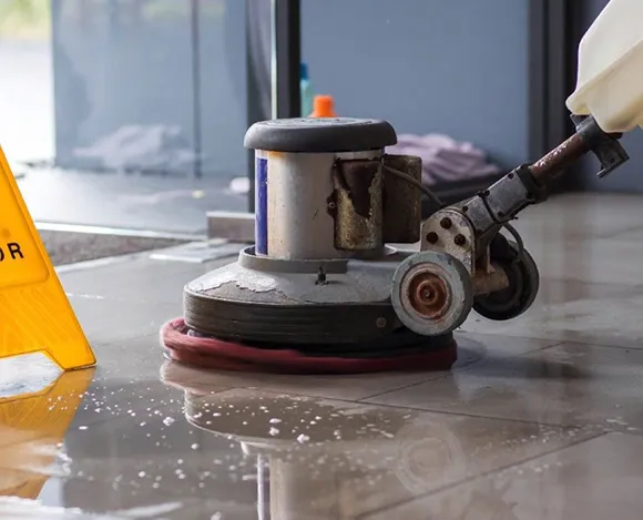 Floor buffer machine polishing a hard floor during deep cleaning after construction in Ann Arbor MI.