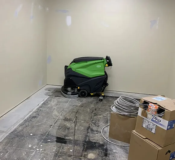 Green floor cleaning machine in a commercial space for floor stripping and refinishing services in Ann Arbor MI.