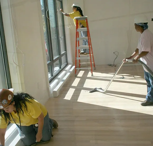Cleaning crew working on a post-construction site with ladder and cleaning supplies in Ann Arbor MI.