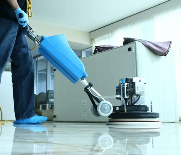 Professional operating a commercial floor cleaning machine in Detroit MI.