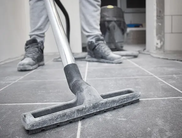 Squeegee cleaning a tile floor during final construction cleaning in Kalamazoo MI.