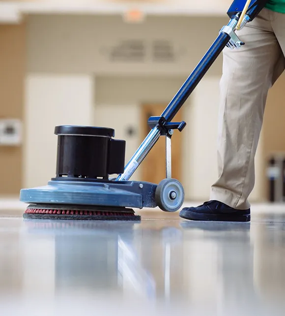 Professional using a floor machine for VCT floor stripping in Ann Arbor MI.