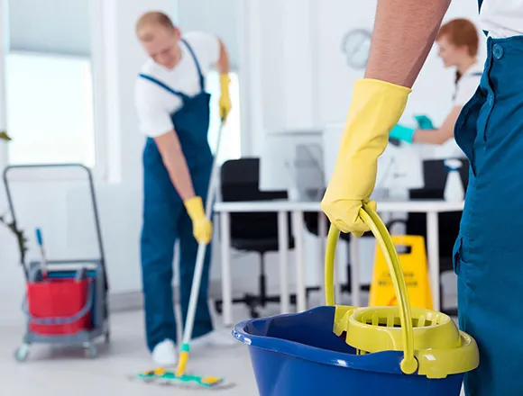 Janitorial staff with cleaning equipment in an office hallway in Kalamazoo MI.