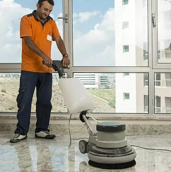 Professional stripping VCT floor tile with a machine in a commercial space in Lansing MI.