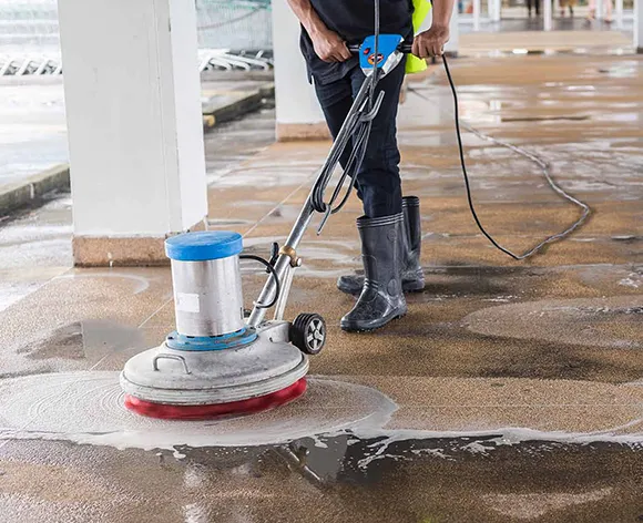 Professional using a floor buffer to clean and polish a commercial floor in Kalamazoo MI.