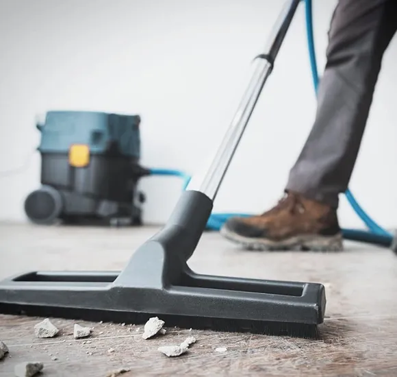 Worker using a floor machine to clean a large area during final construction cleaning in Lansing MI.