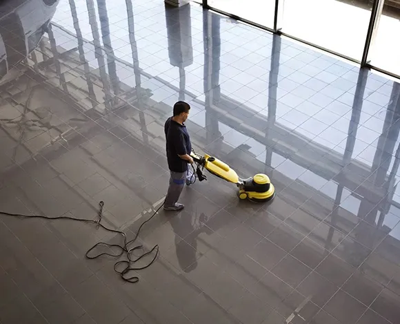 Specialized machine stripping VCT floor in a large commercial space in Detroit MI.
