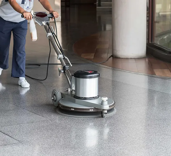 Floor machine stripping VCT tile floor in a commercial building in Grand Rapids MI.