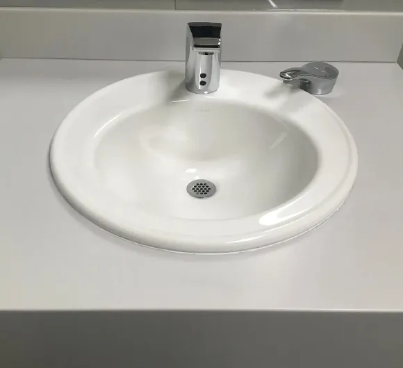 Clean sink and countertop in a bathroom, representing post construction cleaning services in Kalamazoo MI.