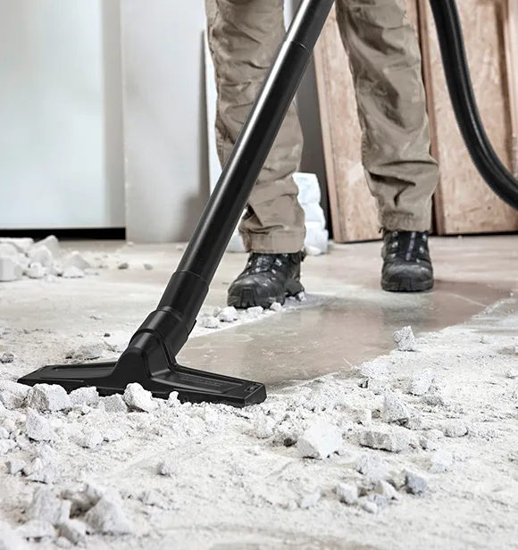 Close-up of vacuum cleaning debris from a floor during construction cleanup in Grand Rapids MI.