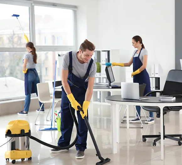 Commercial cleaning crew cleaning an office space with vacuum and other equipment in Kalamazoo MI.